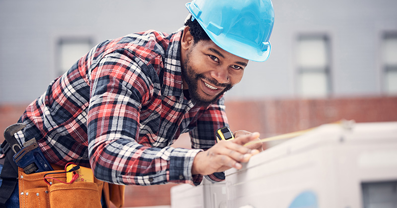 HVAC Technician Smiling and Practicing Safety