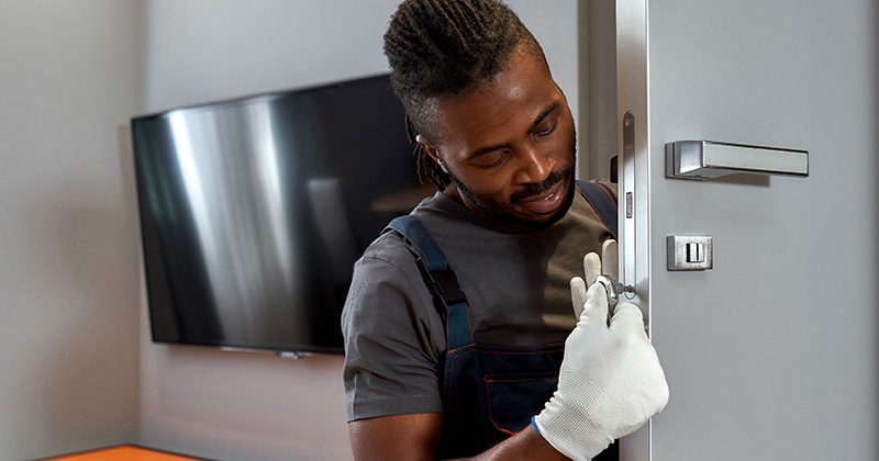 Locksmith Working on a Door Smiling