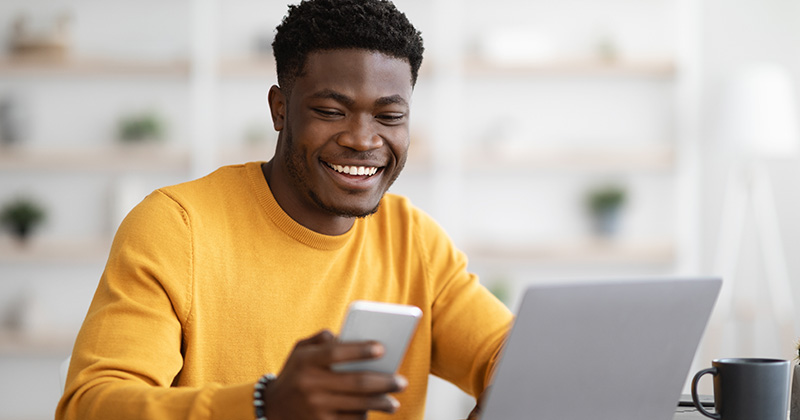 Young man on devices happy