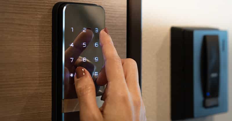 Close up of woman typing on smart lock