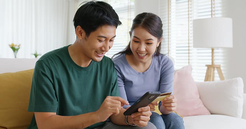 Couple on phone buying smart locks