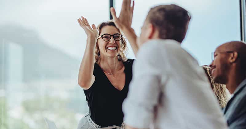 Coworkers giving each other high fives