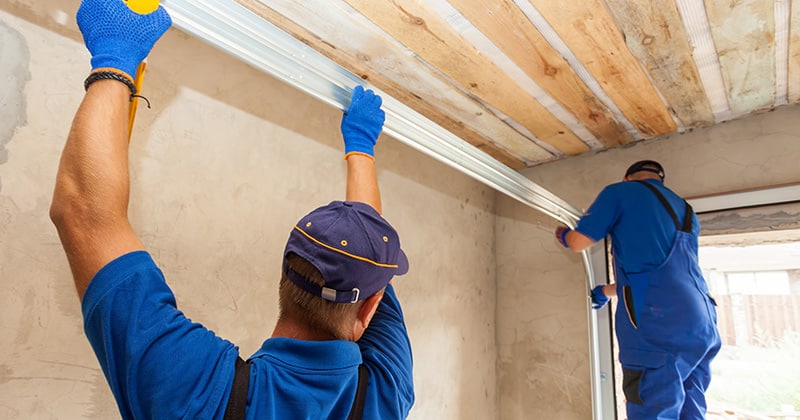 Two men installing garage doors