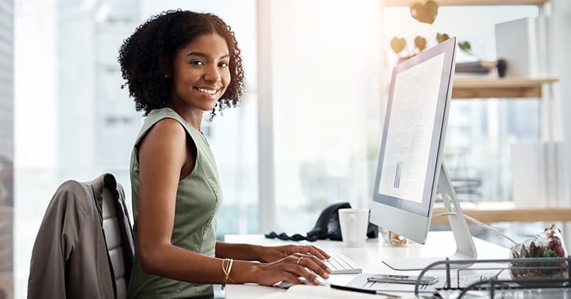 Woman smiling and doing research on recession