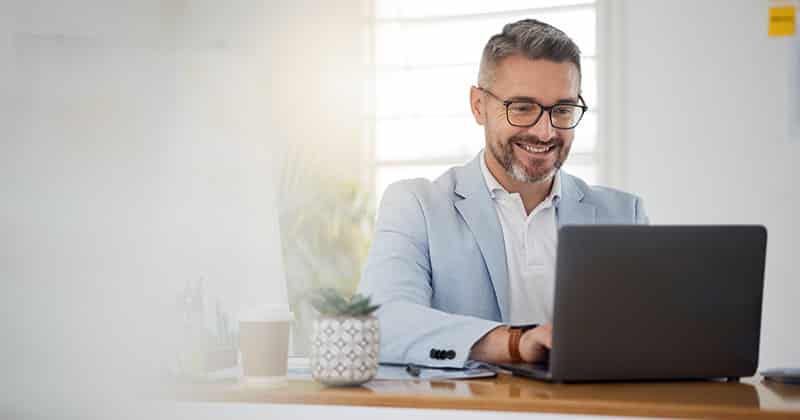 Business man smiling on computer