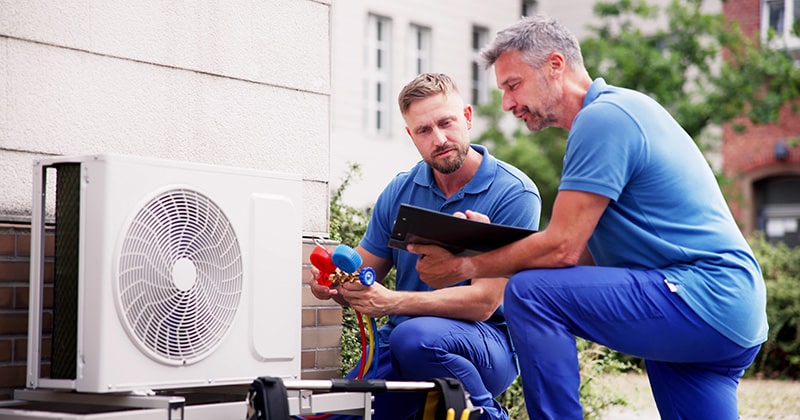 HVAC manager helping technician