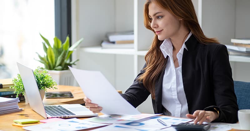 Woman smiling and calculating pricing