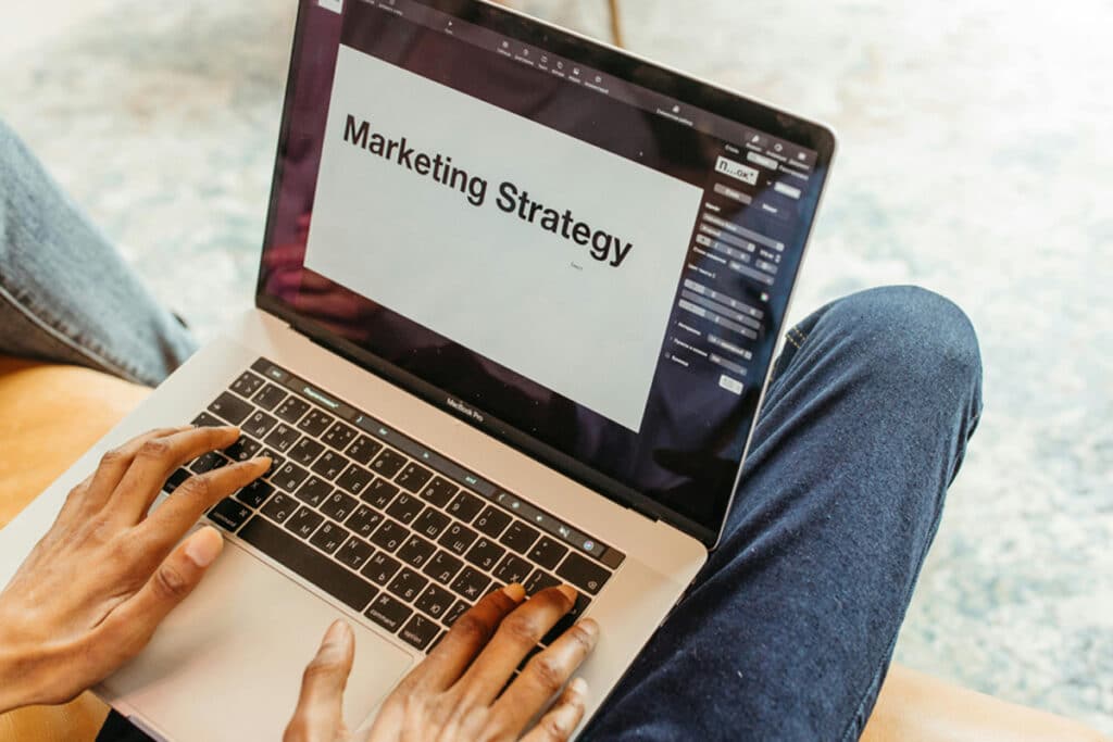 Person managing marketing strategy on a laptop while planning operations for home services business.